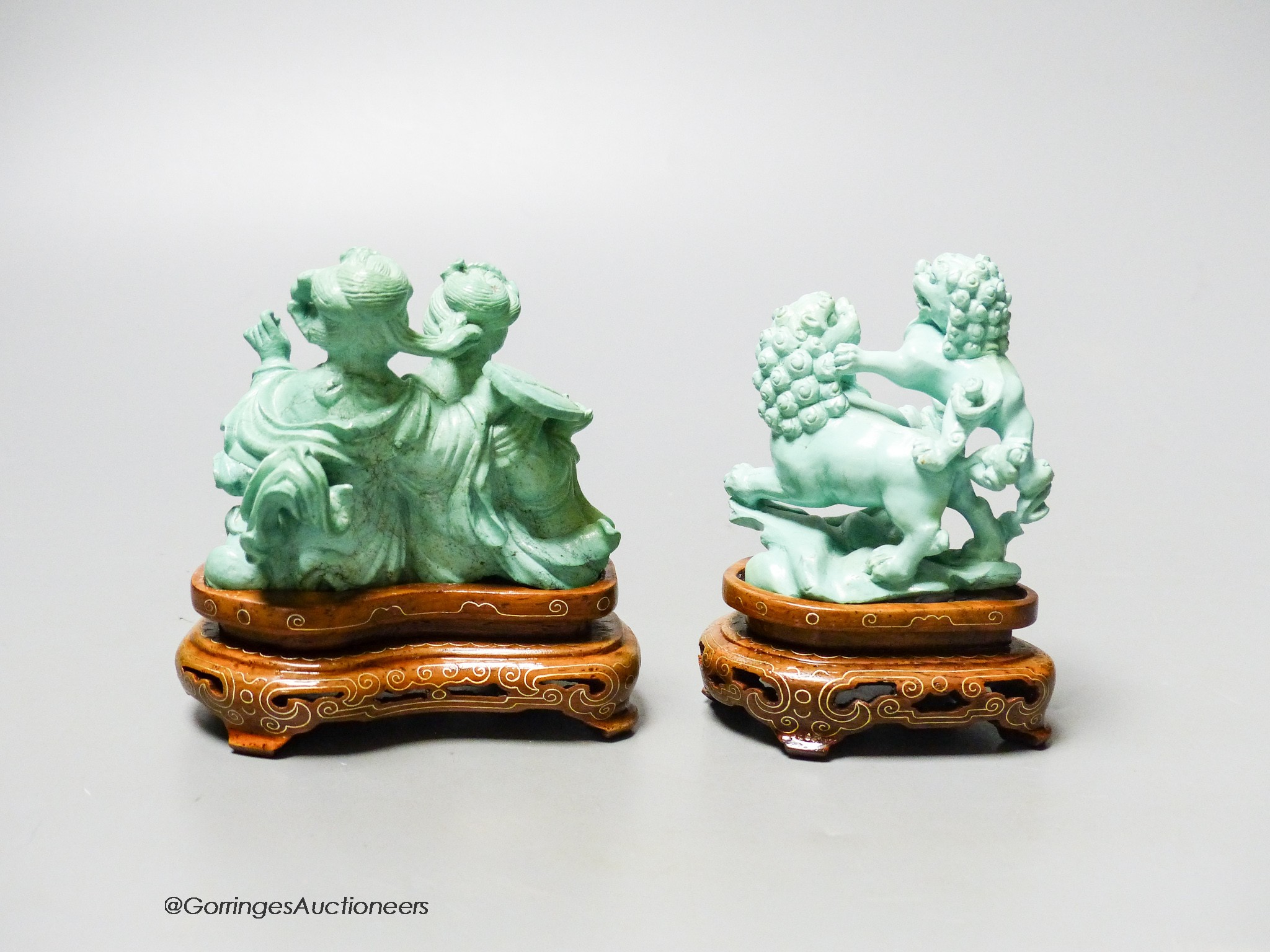 Two Chinese turquoise matrix groups of lion-dogs and of two kneeling ladies, mid 20th century, wood stands, height 9cm